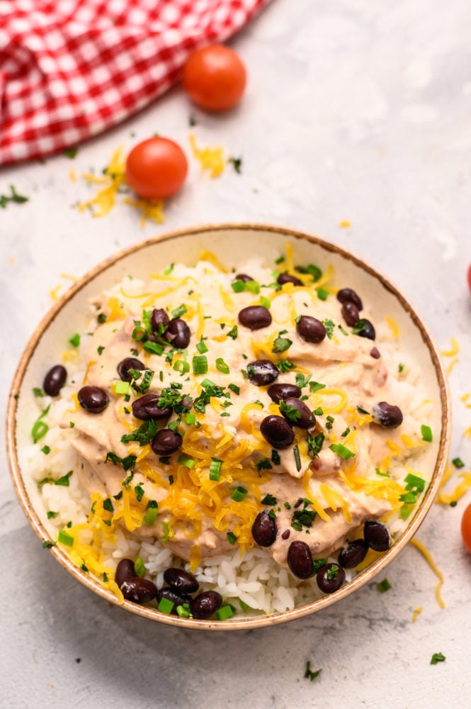 Salsa chicken smothered in rice and black beans all in a bowl. 