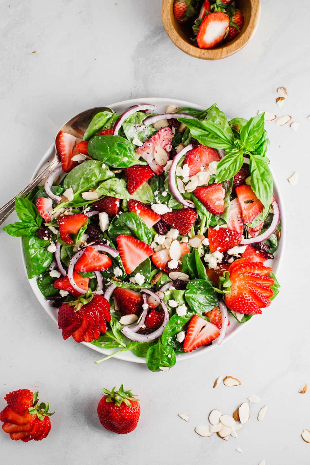 A plate of strawberry spinach salad. 