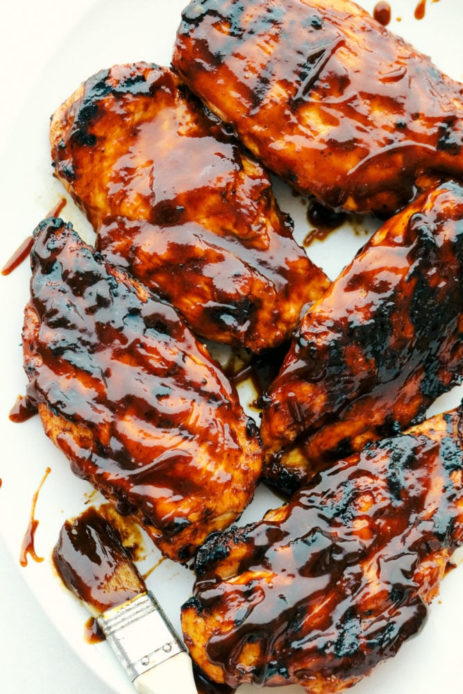 Grilled BBQ chicken covered in barbecue sauce.