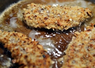 Battered chicken in a frying pan. 