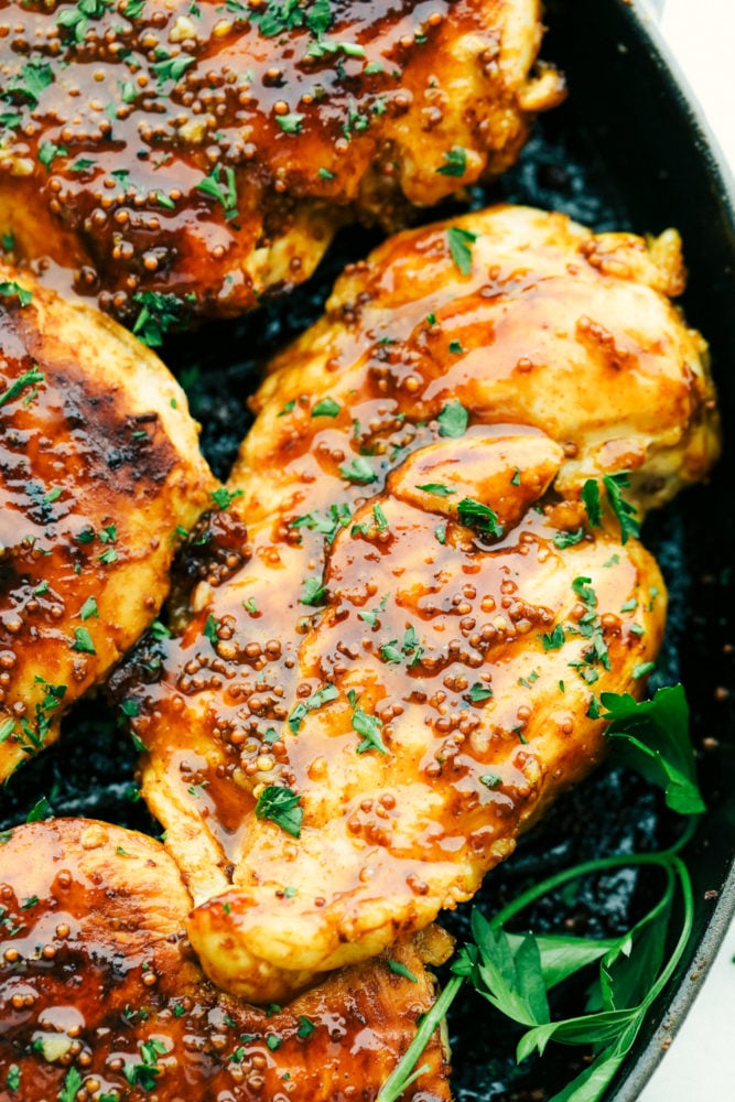 Up close photo of grilled honey mustard chicken on the grill. 