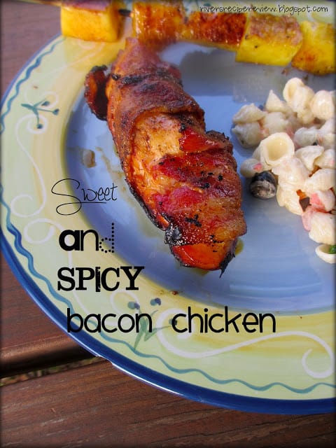 Sweet and Spicy Bacon Chicken on a festive plate with a pineapple skewer and pasta salad. 