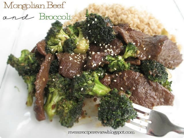 Mongolian Beef and Broccoli with brown rice on a white plate with a metal fork. 