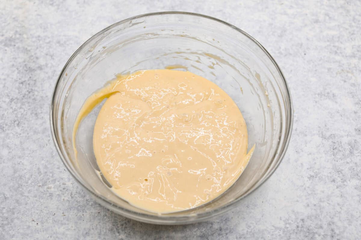 Overhead shot of cheesecake mixture in a glass bowl. 