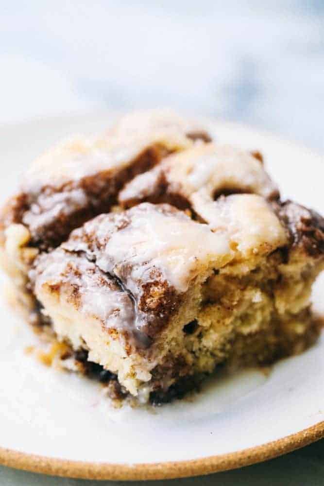 Cinnamon roll cake on a white plate. 