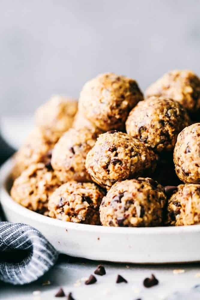 No bake energy bites stacked in a bowl.
