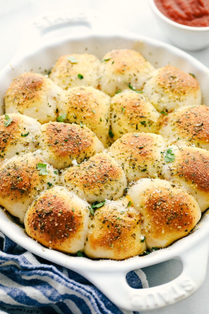 Pizza bites baked with parsley on top of it. 