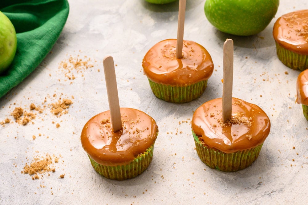 Three caramel apple sticks placed together.