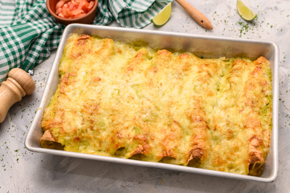 Honey lime chicken enchiladas baked in a pan. 