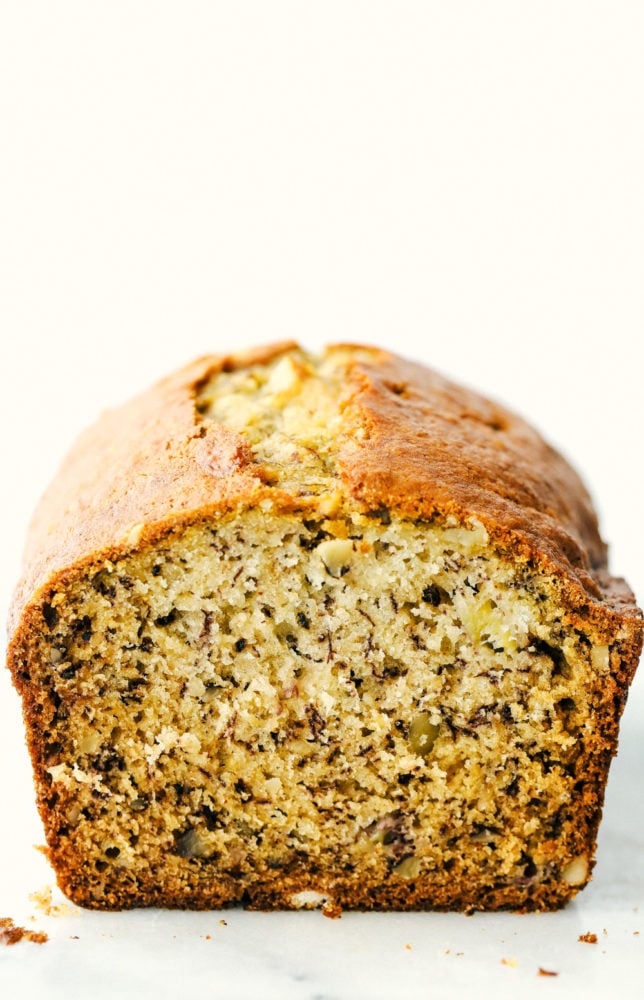 A loaf of banana bread facing the camera then sliced showing the middle of the bread. 