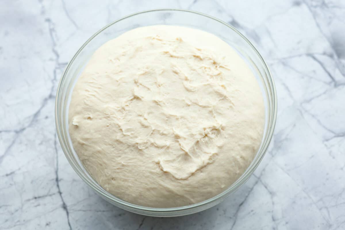 Overhead shot of dough ball that has risen to double its size. 