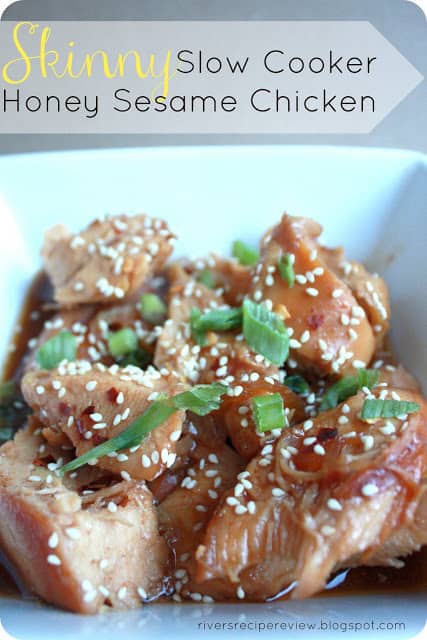 Skinny slow cooker honey sesame chicken in a white bowl garnished with sesame seeds. 