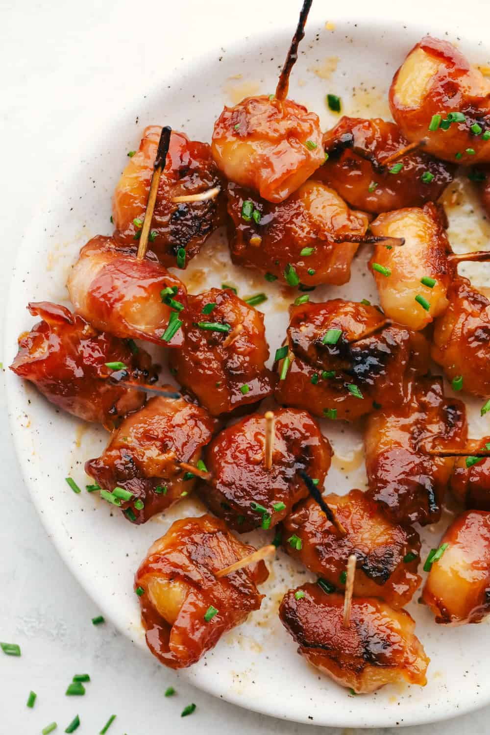 Savory bacon wraps crunchy chestnuts in a sweet spicy sauce.