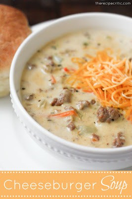 Cheeseburger Soup in a white bowl with shredded cheese on top.
