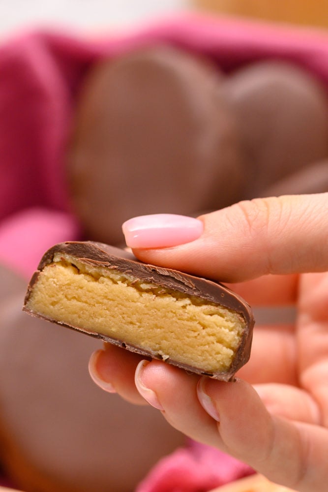 A homemade Reese's egg cut in half to see the peanut butter inside and chocolate outside. 