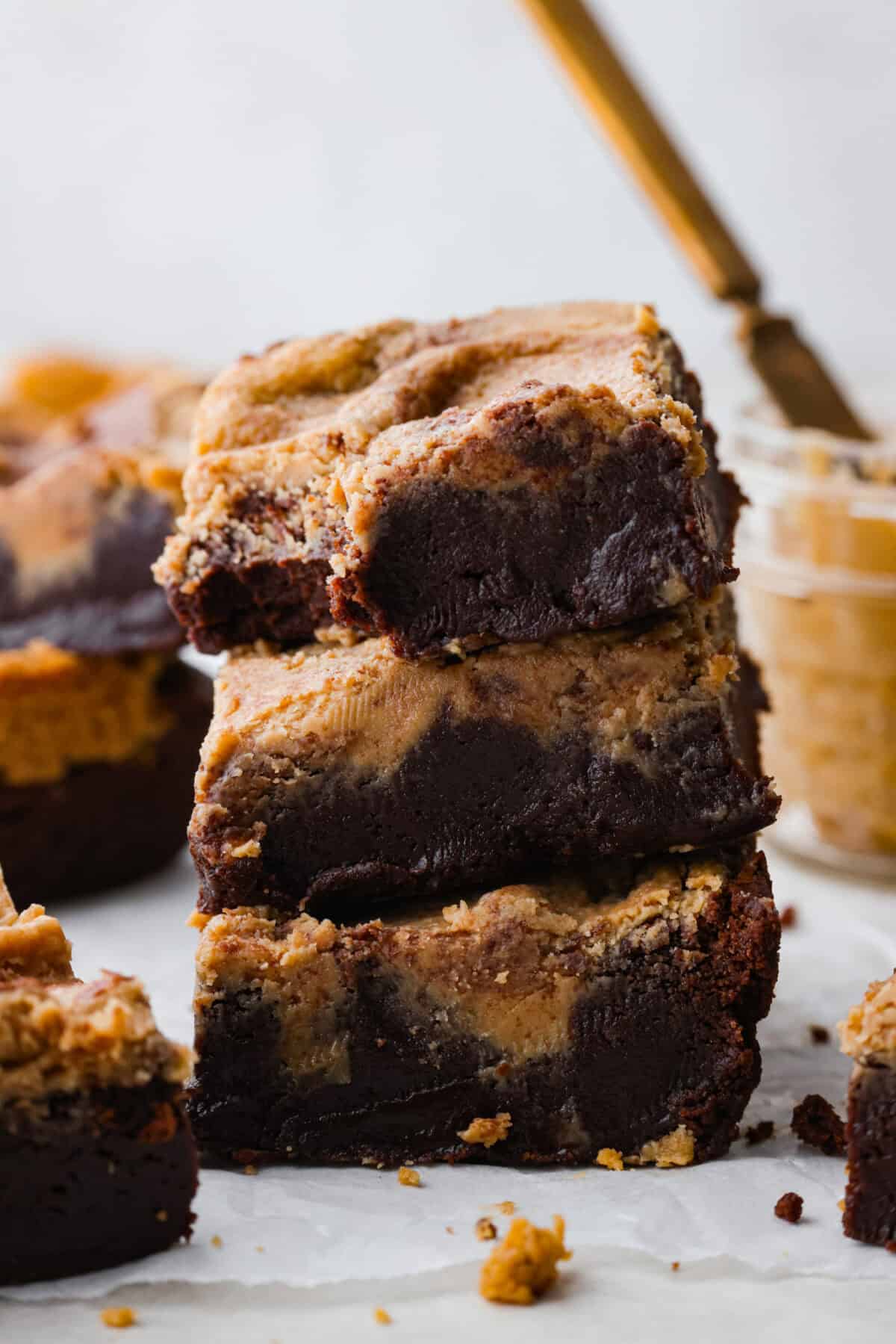 Close view of a stack of peanut butter brownies with a bite taken out of one of them. 