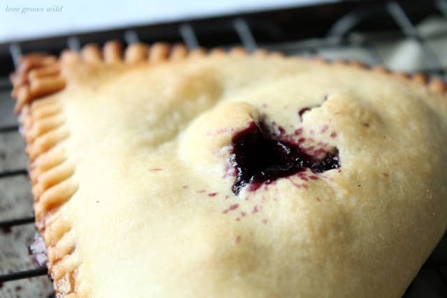 Blueberries and Cream Hand Pies close up of blueberry inside filling by LoveGrowsWild.com for The Recipe Critic