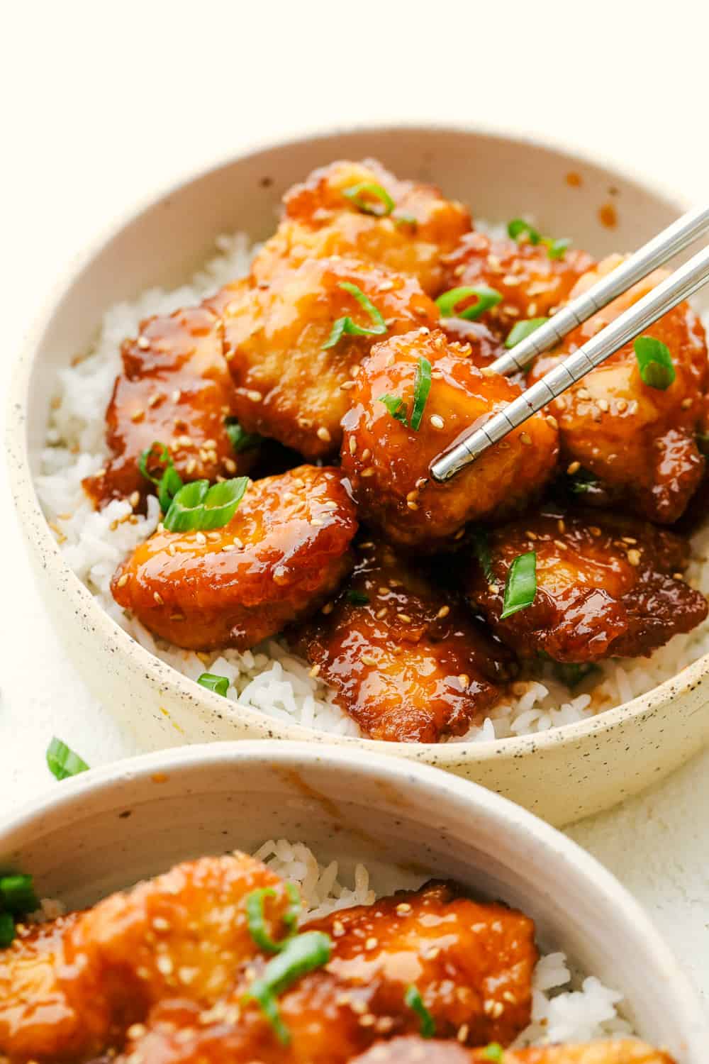 Juicy, tender Baked Sweet and Sour Chicken on top of rice.