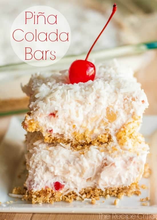 Pina Colada Bars on a white plate with a cherry on top.