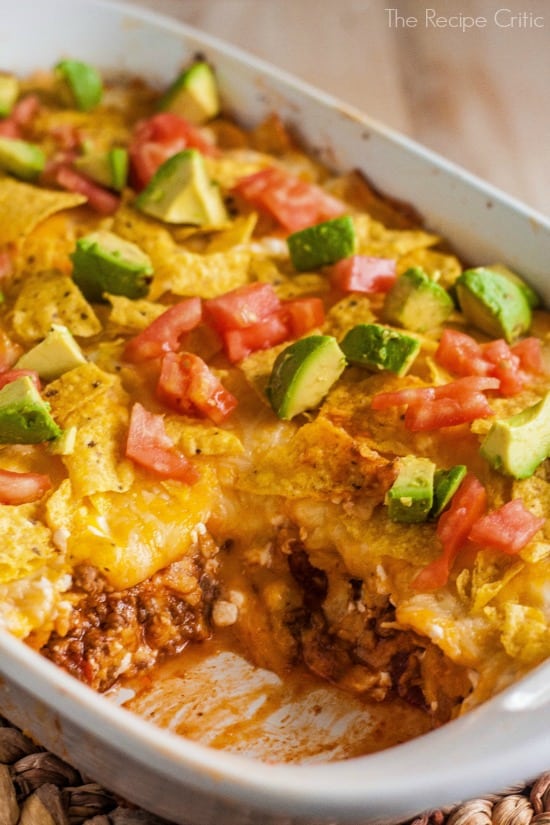Texas casserole in a white baking dish with one piece missing to show the flavorful inside.