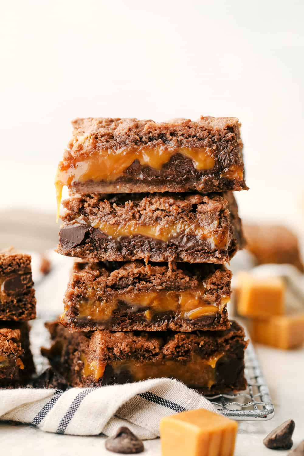 Caramel Brownies stacked on top of each other. 