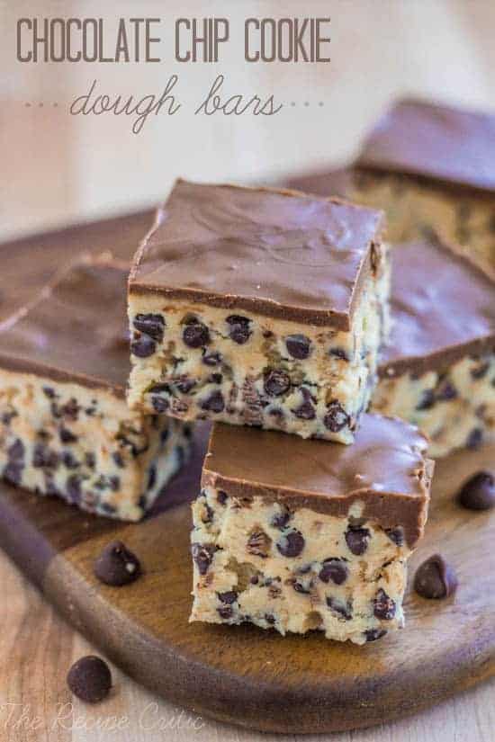 Chocolate chip cookie dough bars stacked on a wooden table.