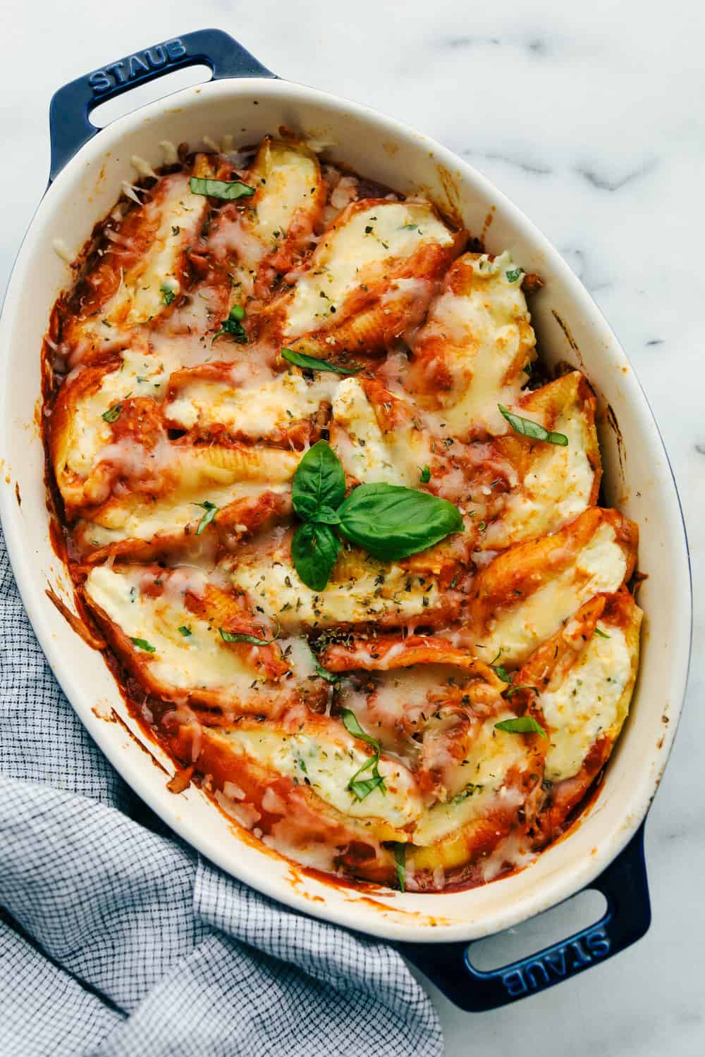 Three cheese stuffed shells baked in a pan. 