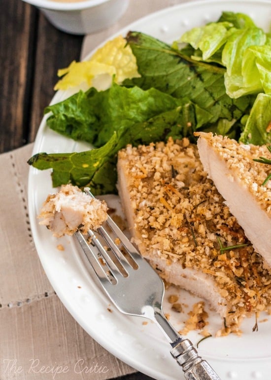 Walnut crusted chicken sliced on a white plate.