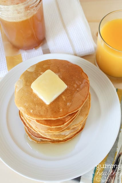 Stack of pumpkin pancakes on a white plate.