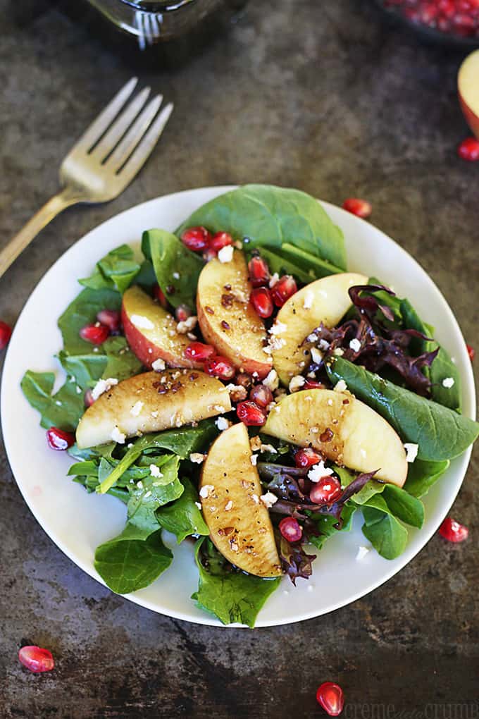 Apple Pomegranate Salad with Honey Balsamic Dressing on a white plate.