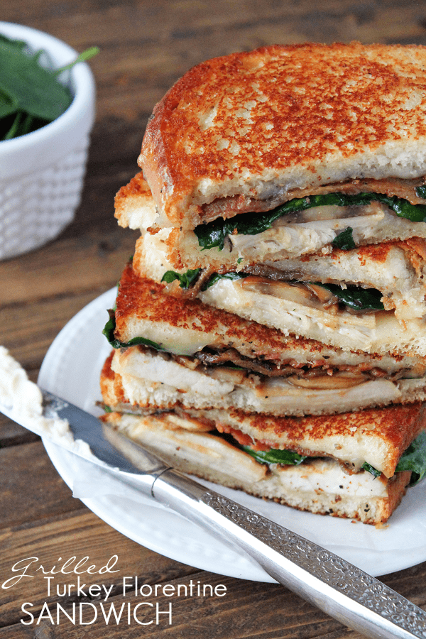 Grilled Turkey Florentine Sandwiches in a stack on a white plate by Love Grows Wild for The Recipe Critic