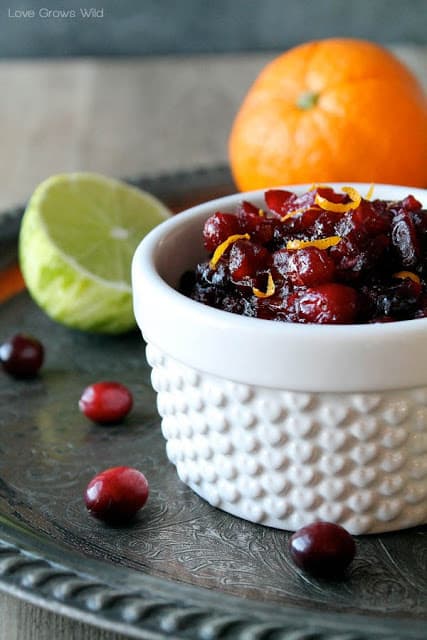 Orange and Lime Cranberry Sauce in a white small cup.