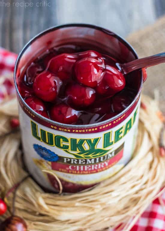 An open can of lucky leaf cherries.