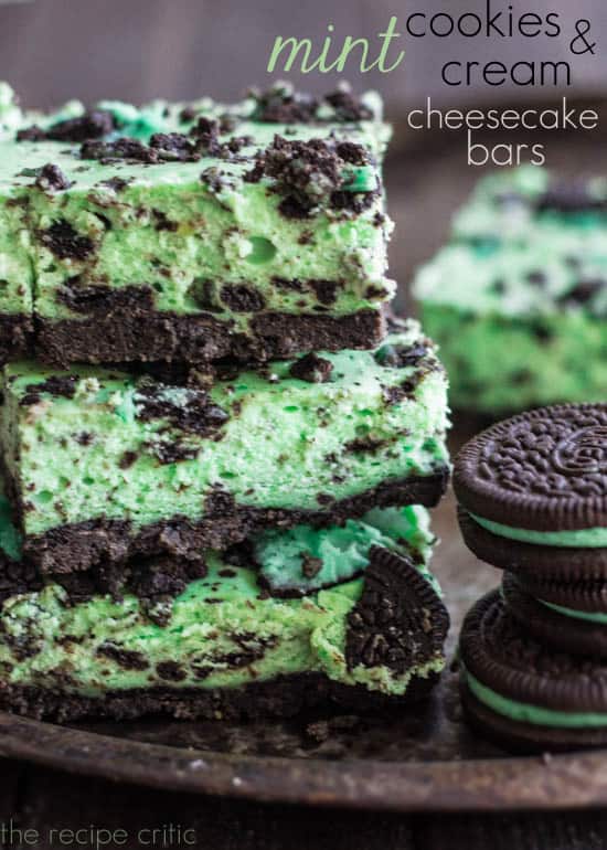Mint cookies and cream cheesecake bars with mint oreos in a stack.