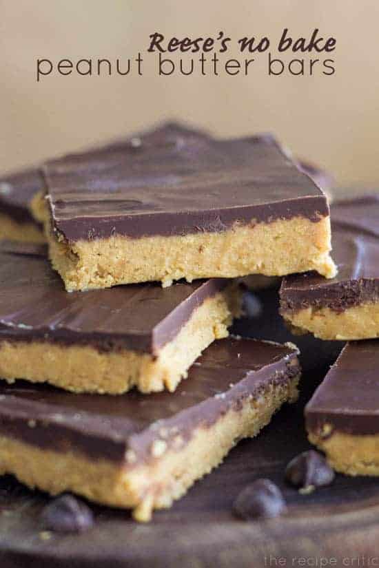 Reese's No Bake Peanut Butter Bars stacked on top of one another on a wooden plate. 