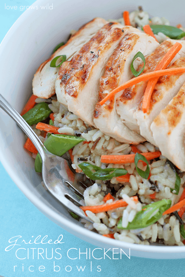 Grilled Citrus Chicken Rice Bowl in a white bowl with a metal fork. 