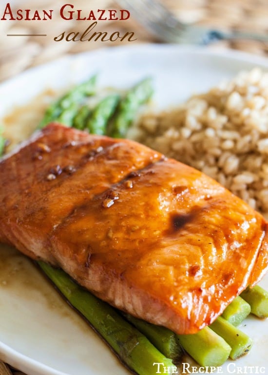 Asian Glazed Salmon over asparagus on a white plate. 