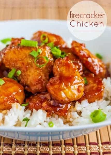 Firecracker Chicken over white rice on a white bowl. 