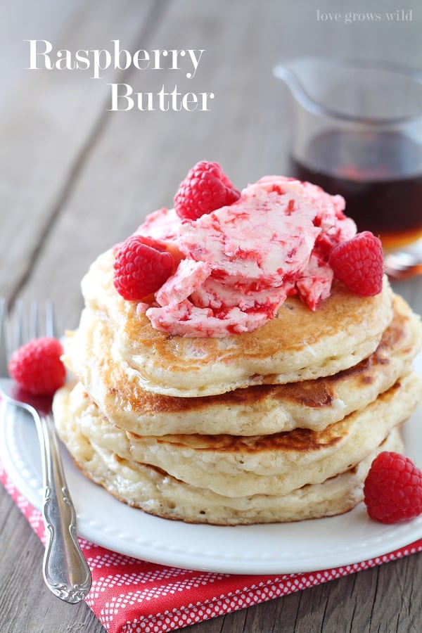 Raspberry Butter on pancakes on a white plate with a metal fork. 