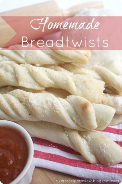 Homemade Breadtwists on a red and white striped towel with tomato sauce. 