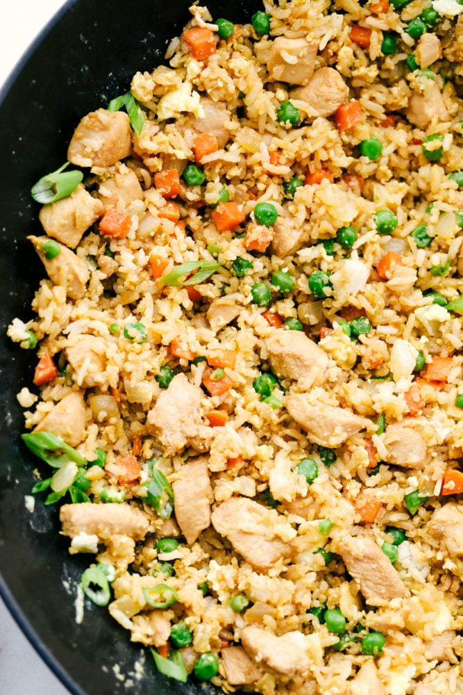 Chicken fried rice in a skillet. 