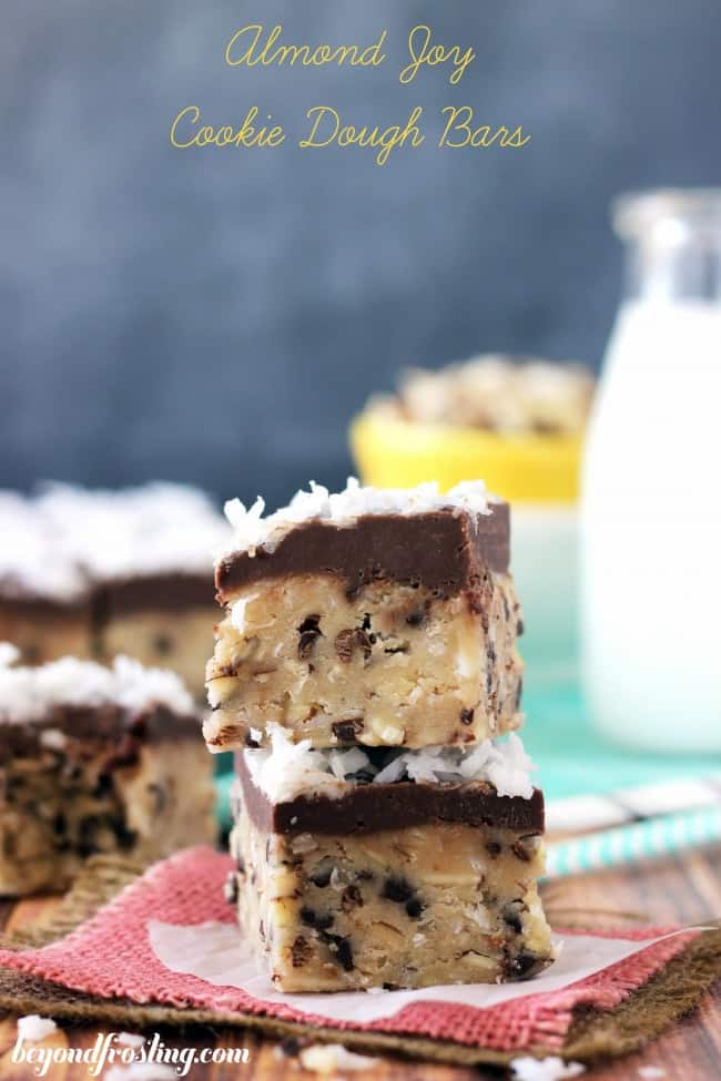 Almond joy cookie cough bars stacked on top of one another. 