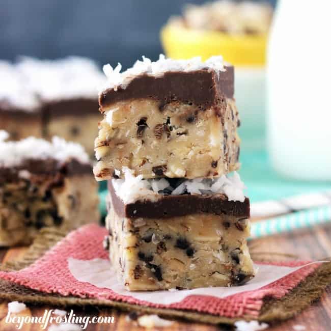 Almond Joy Cookie Dough Bars stack on top of one another. 