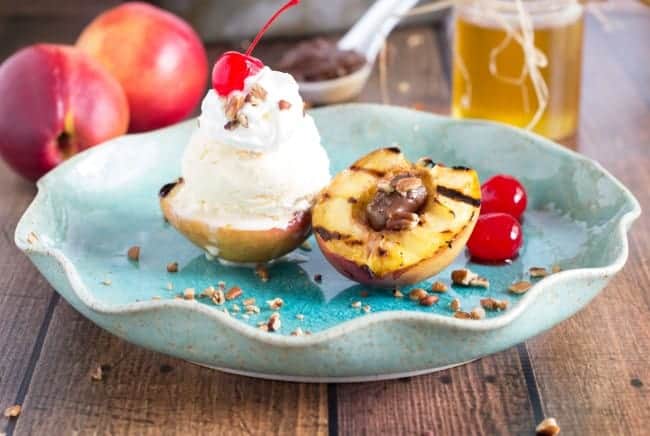 Grilled Nectarine Sundae on a blue plate on a wooden table. 
