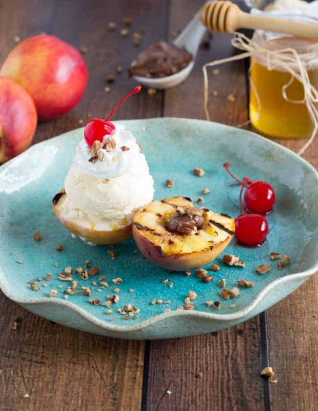 Grilled Nectarine Sundae on a blue plate on a wooden table. 