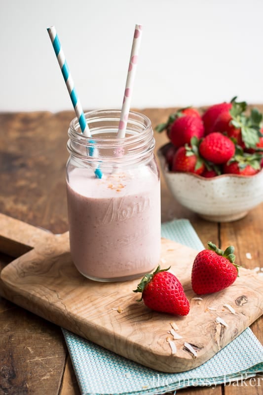 Strawberry Coconut Smoothie in a mason jar with straws. 