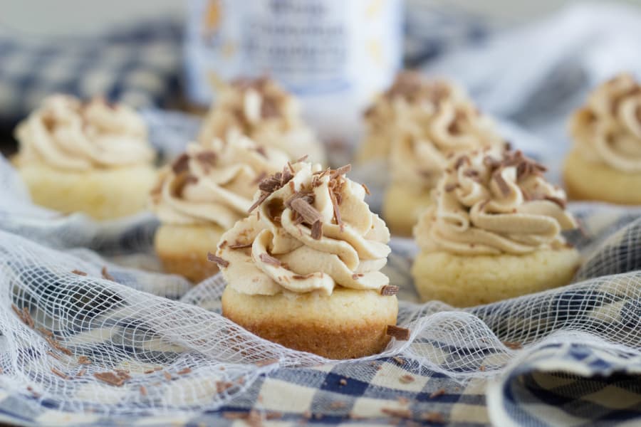 Miniature sugar cookie cups that are filled with a peanut butter mousse and garnished with chocolate shavings