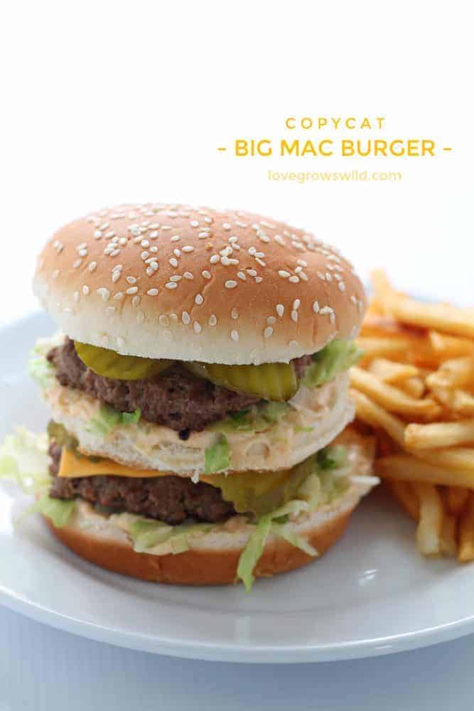 Big Mac Burger on white plate with fresh fries on the side. 