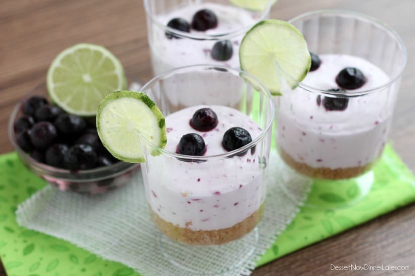 Blueberry Lime No-Bake Cheesecake Cups with fresh lime and blueberries on the side. 