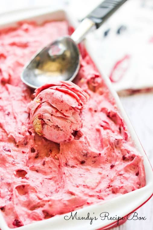 Raspberry Cheesecake Ice Cream with an ice cream scoop. 